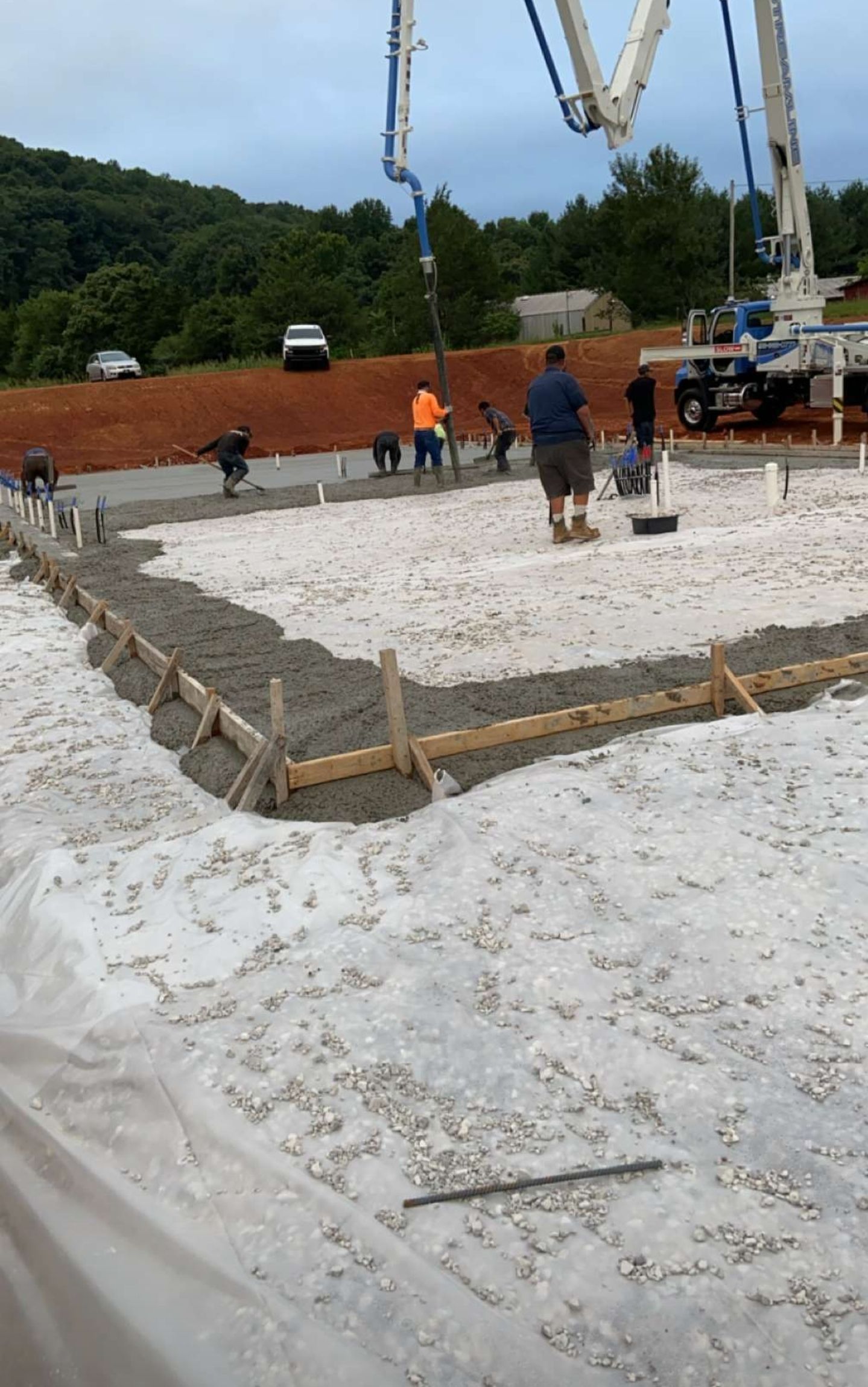 A concrete pump is being used to pour concrete on a construction site.
