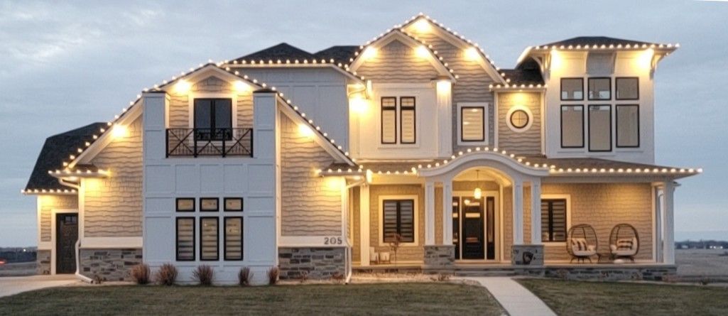 A large white house with christmas lights on it