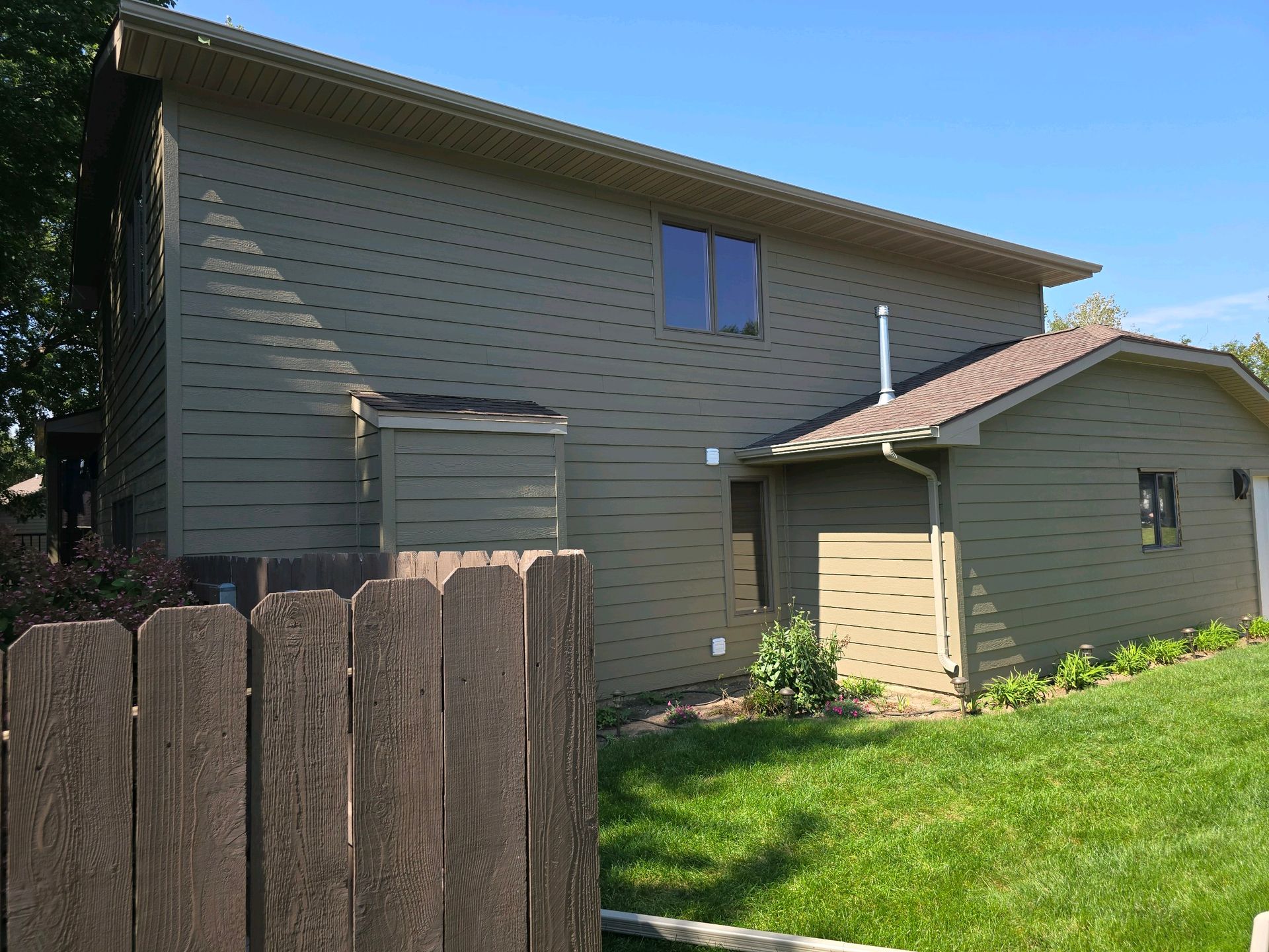 A house with a wooden fence in front of it