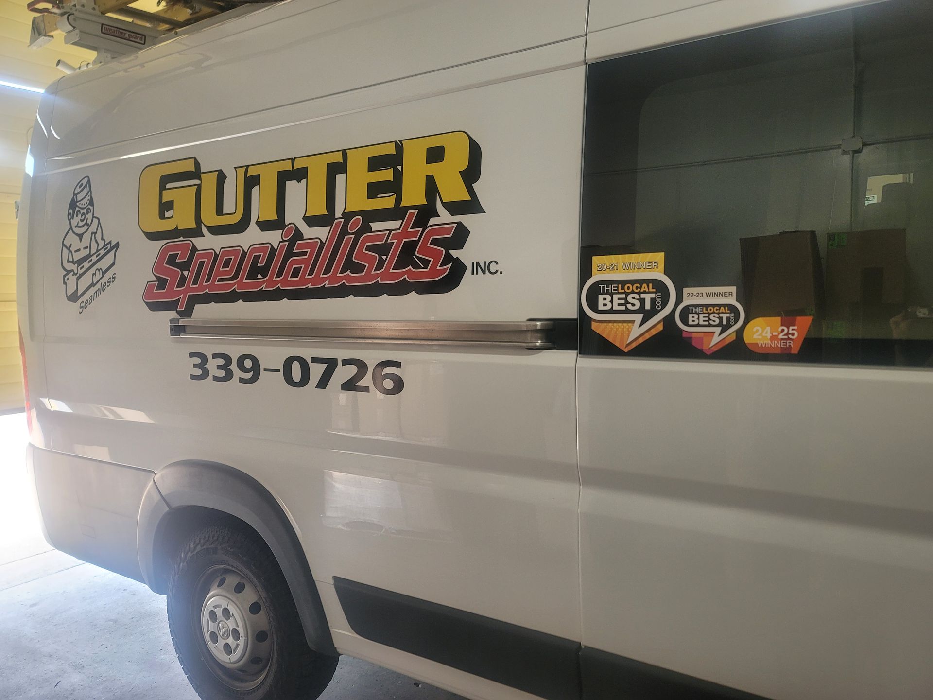 A white van with gutter specialists written on it
