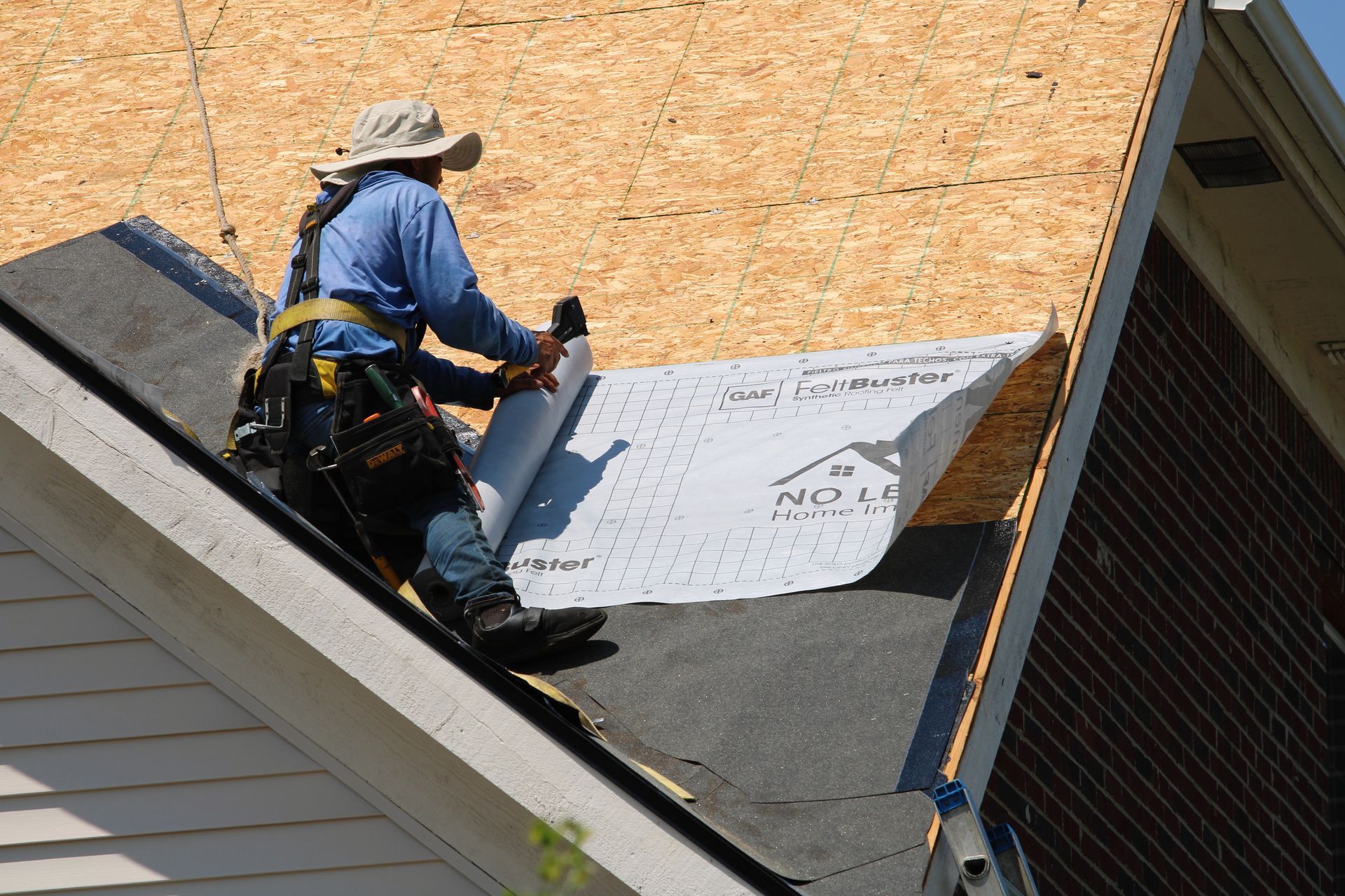 A man is working on the roof of a house