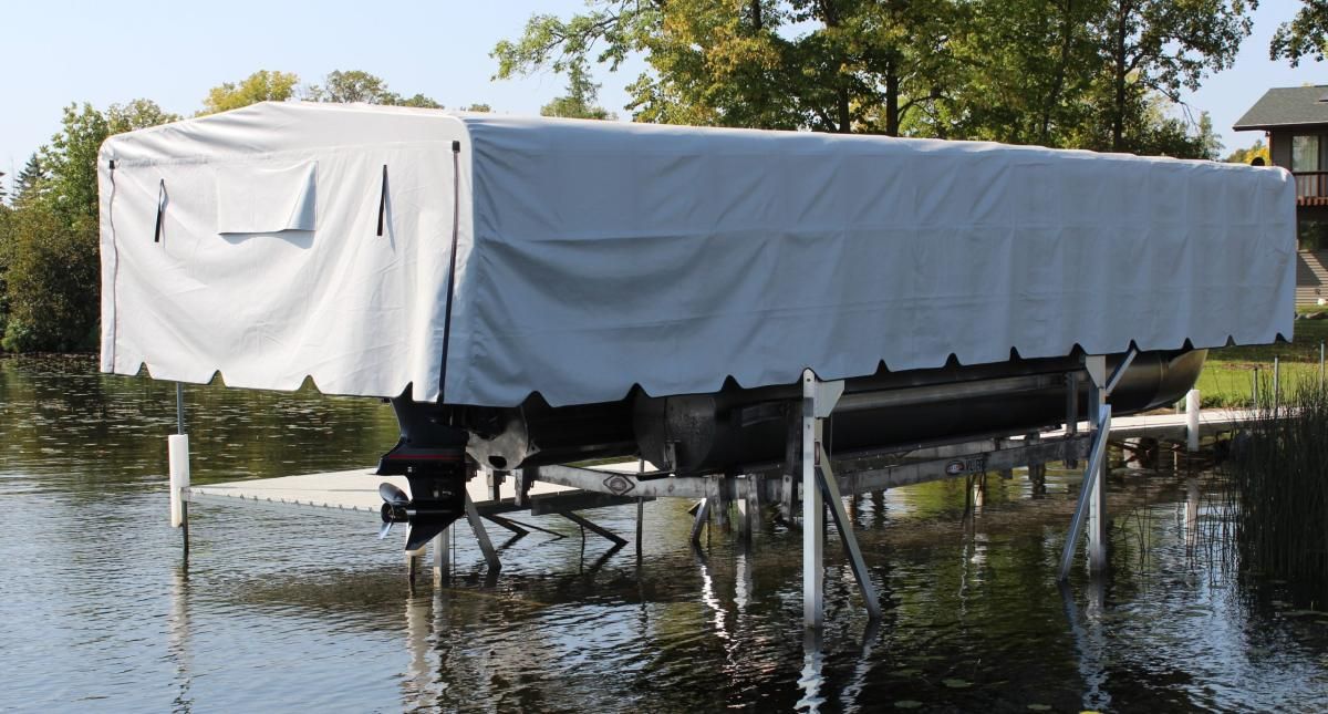 A boat is sitting on a dock with a white tarp over it