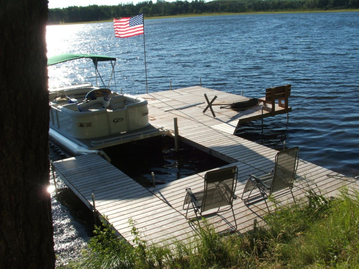 A boat is docked at a dock with an american flag