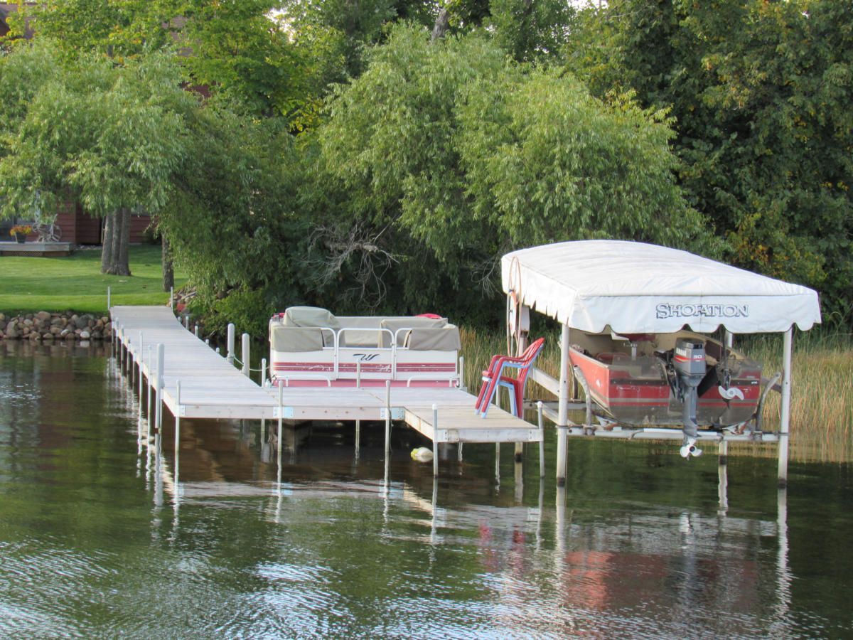 A boat is docked at a dock on a lake