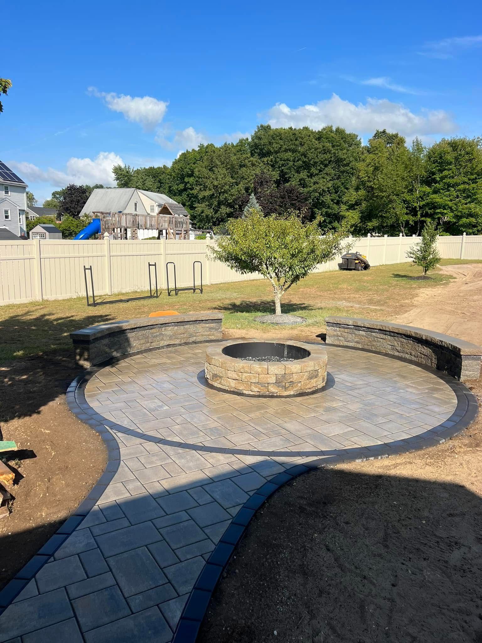 There is a fire pit in the middle of the backyard.