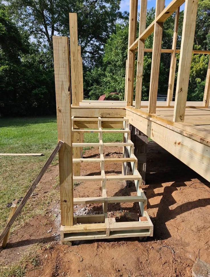 A wooden staircase is being built on top of a wooden deck.
