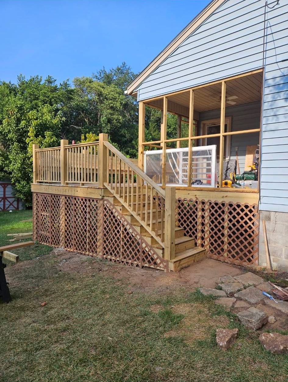 A wooden deck is being built on the side of a house.
