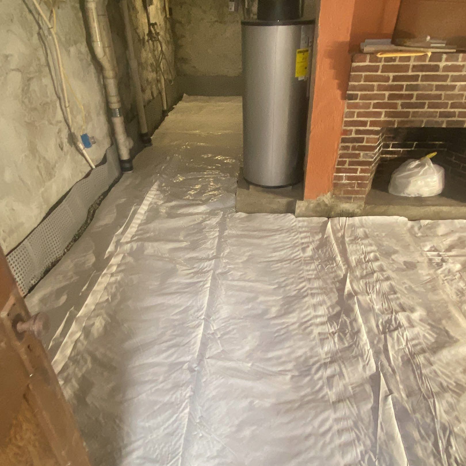 A basement with a water heater and a fireplace.