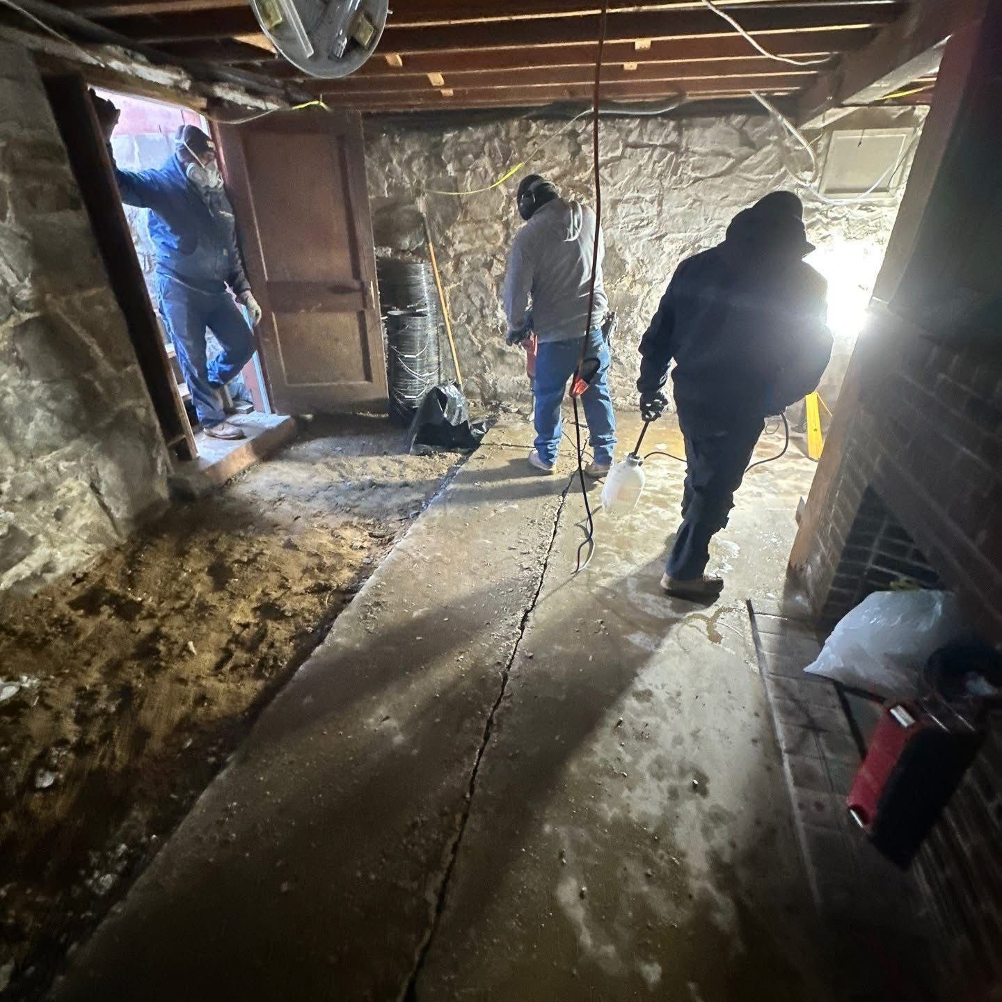 A group of men are working in a basement.