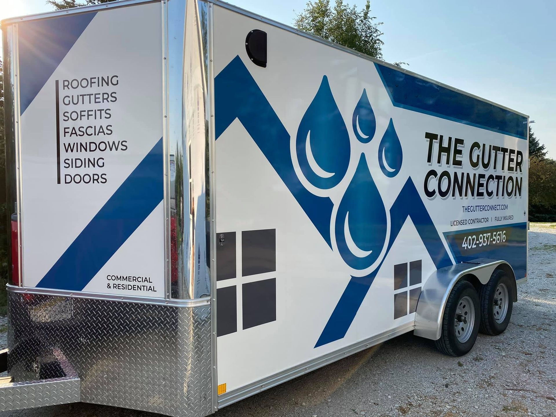 White-and-blue trailer for “The Gutter Connection” with gutter, soffit, siding, fascia, and windows services listed.