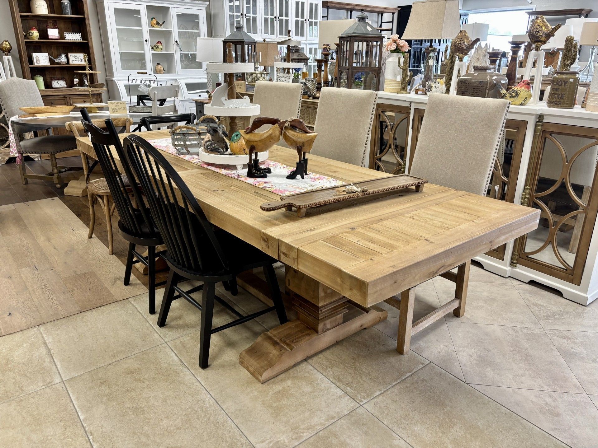 A wooden dining table with black chairs in a room.