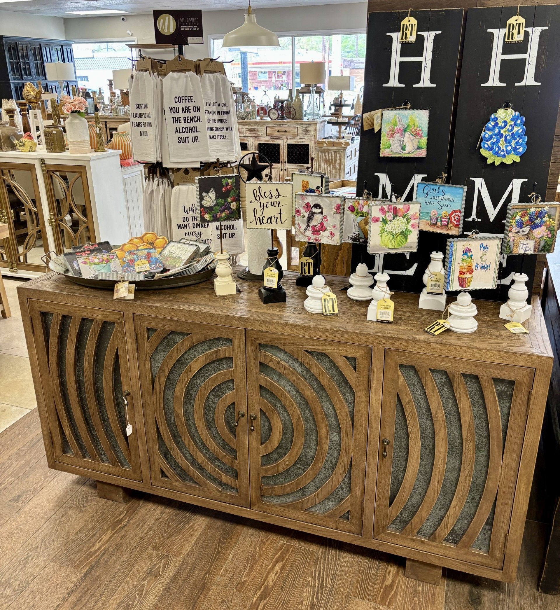 A wooden table with a lot of items on it in a store.