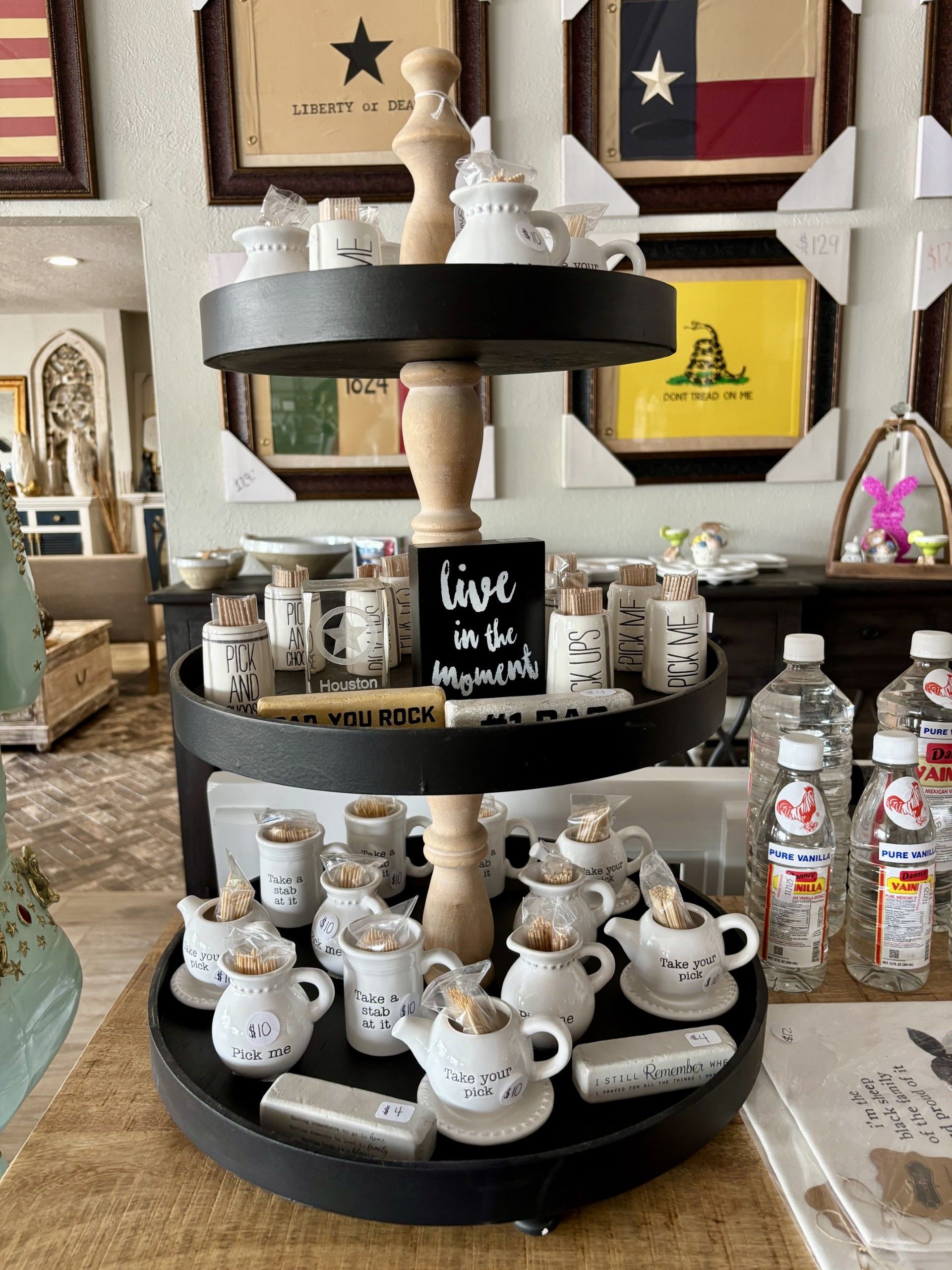 A three tiered display with a sign that says live in the moments.