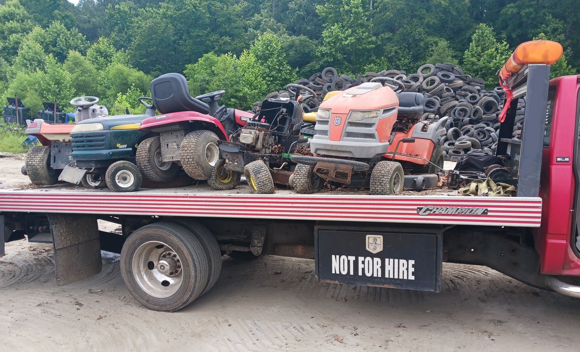 A red tow truck has a sign on the back that says not for hire