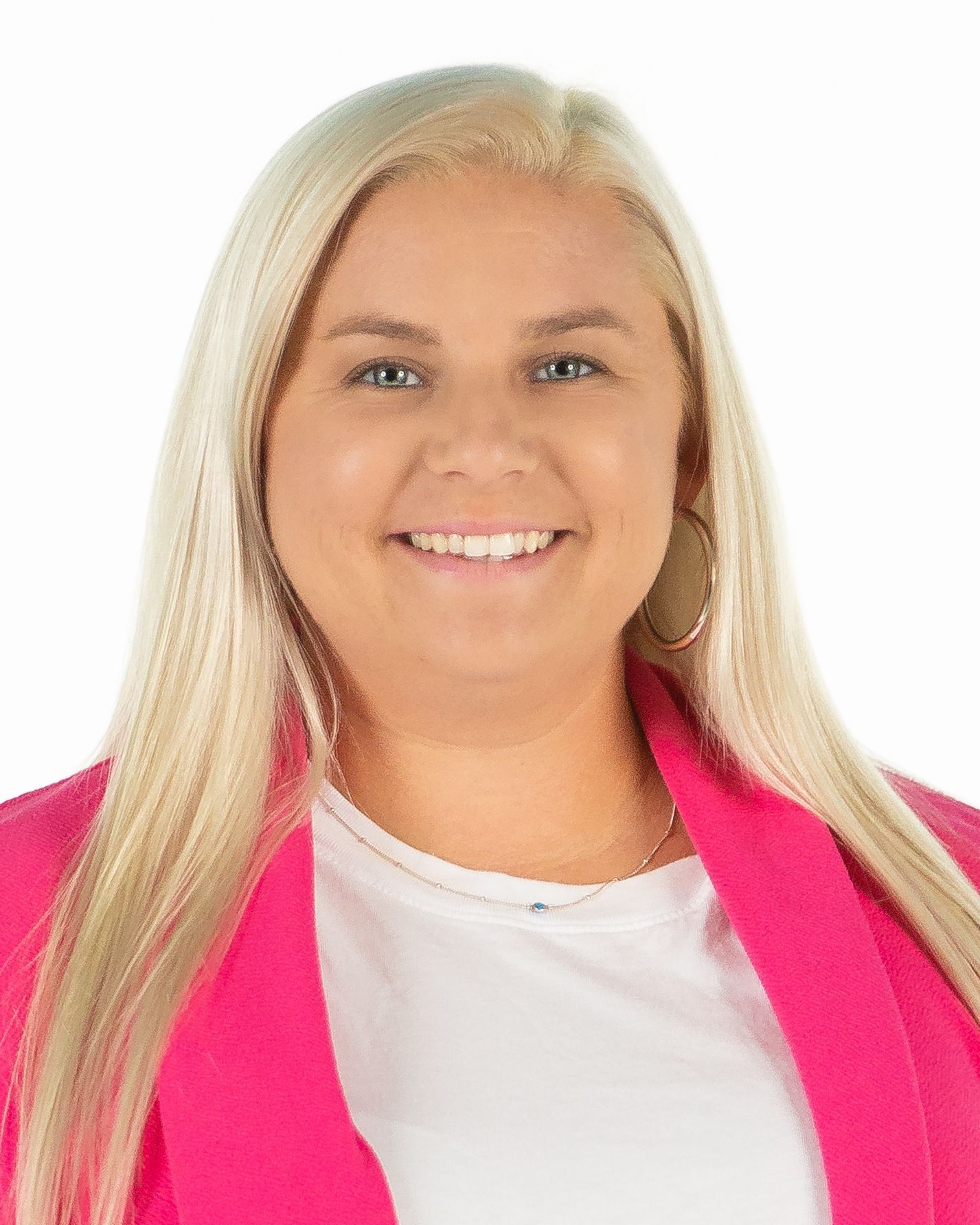 Smiling blonde woman in a bright pink blazer on a white background