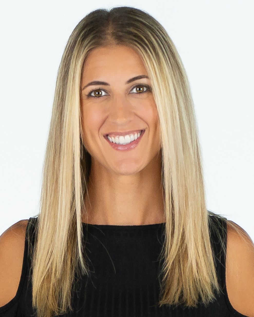 Smiling woman with straight blonde hair wearing a black top against a white background