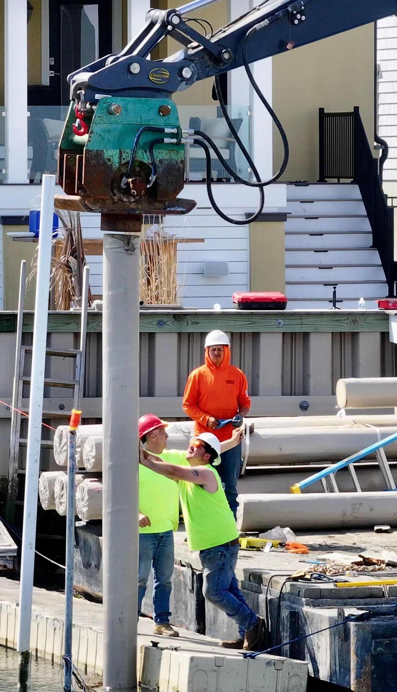 A group of construction workers are working on a dock.