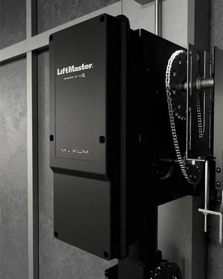 Black LiftMaster gate opener attached to a wall.