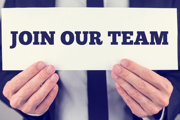A man is holding a sign that says join our team