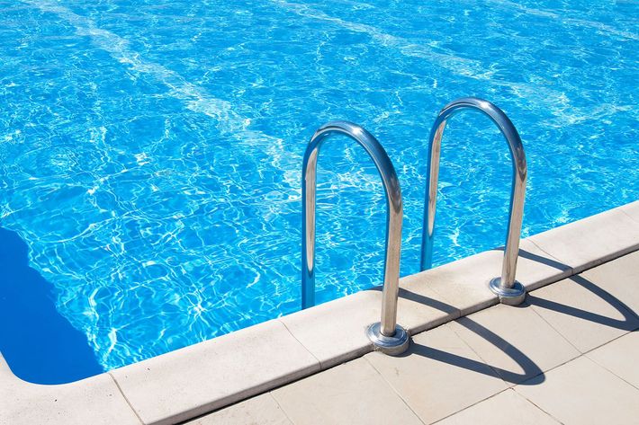 A swimming pool with a set of stairs leading into it.