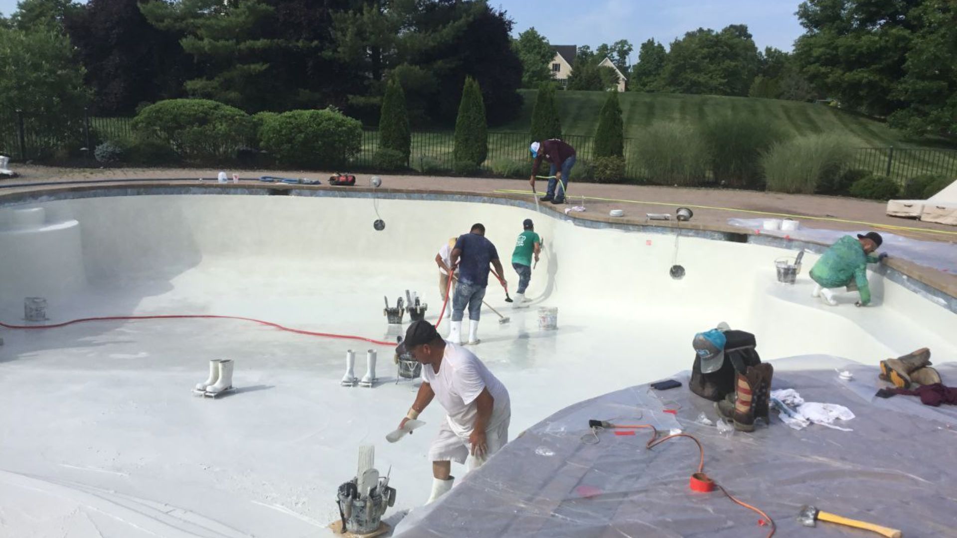 A group of people are working on a swimming pool.