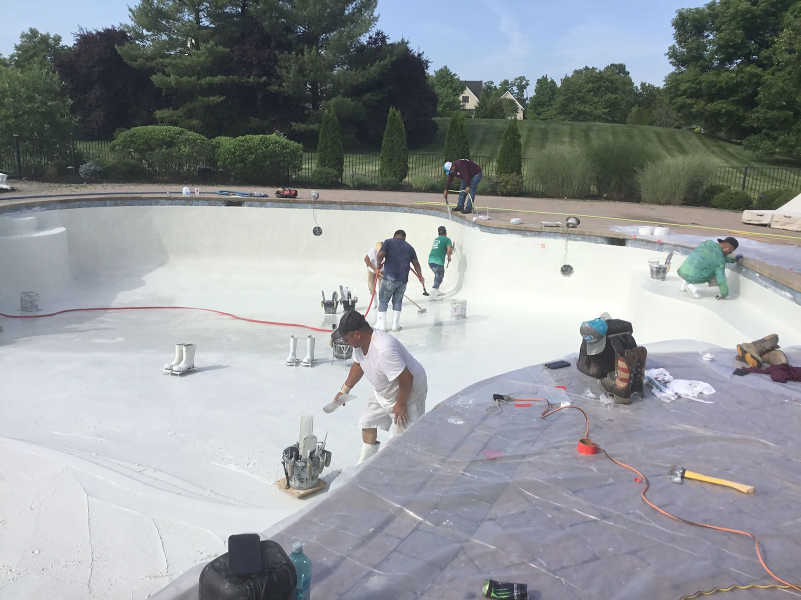Workers doing a pool plaster repair