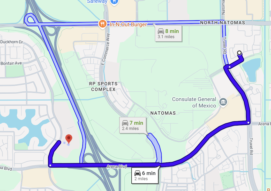 Map showing a blue route through streets around a large green park area.