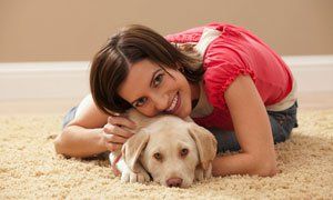 Woman and her pet on a carpet