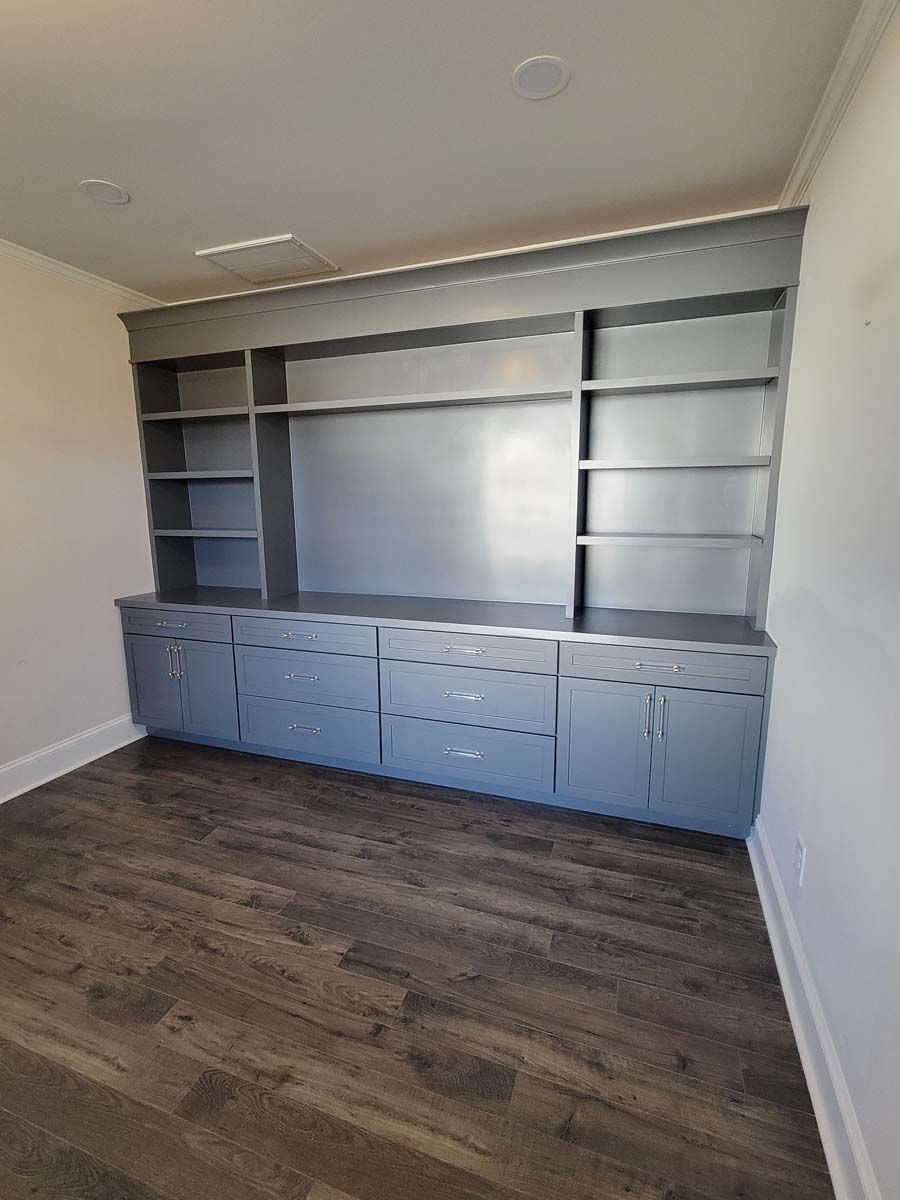 There is a large entertainment center in the corner of the room.