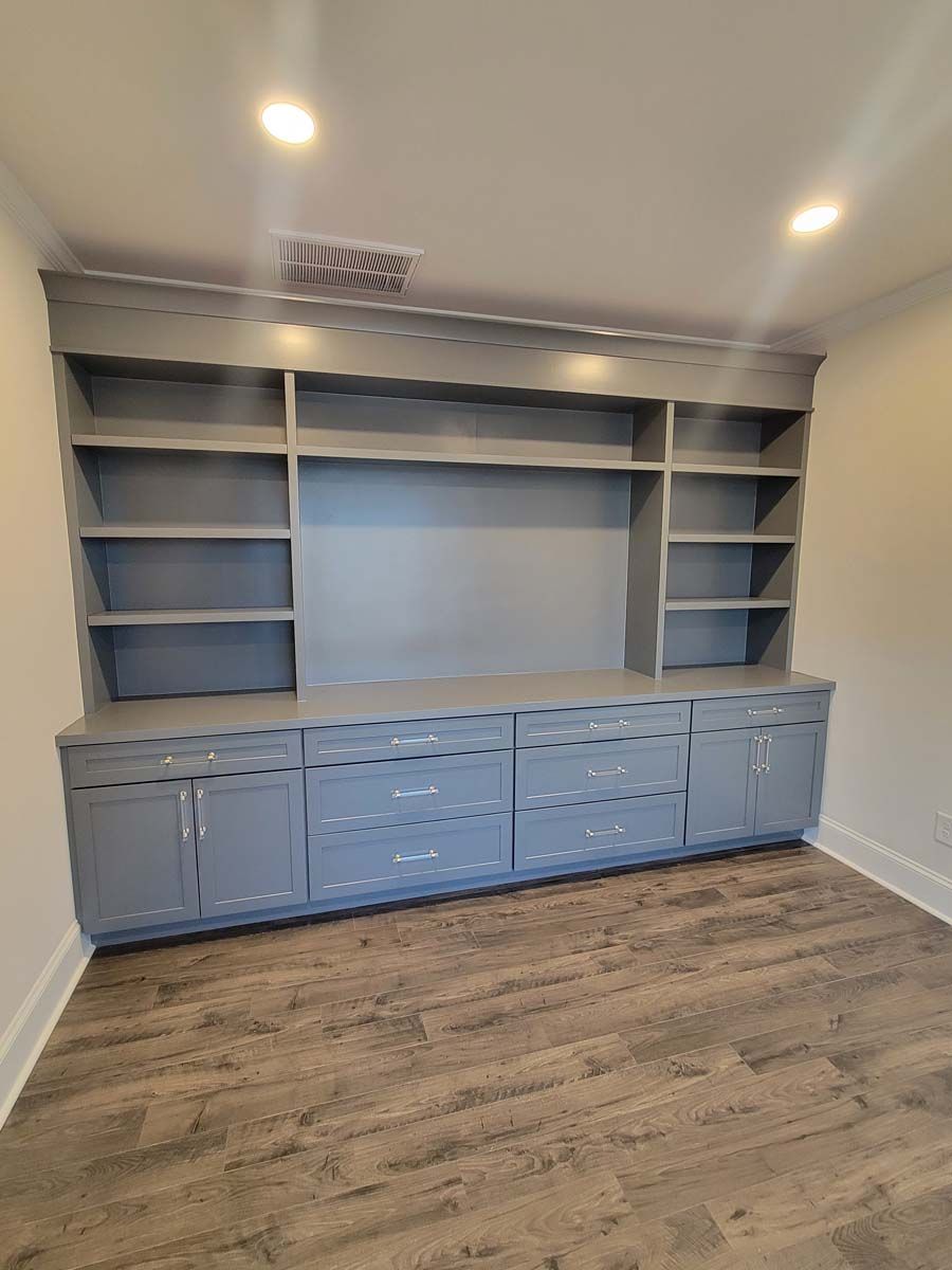 There is a large entertainment center in the middle of the room.