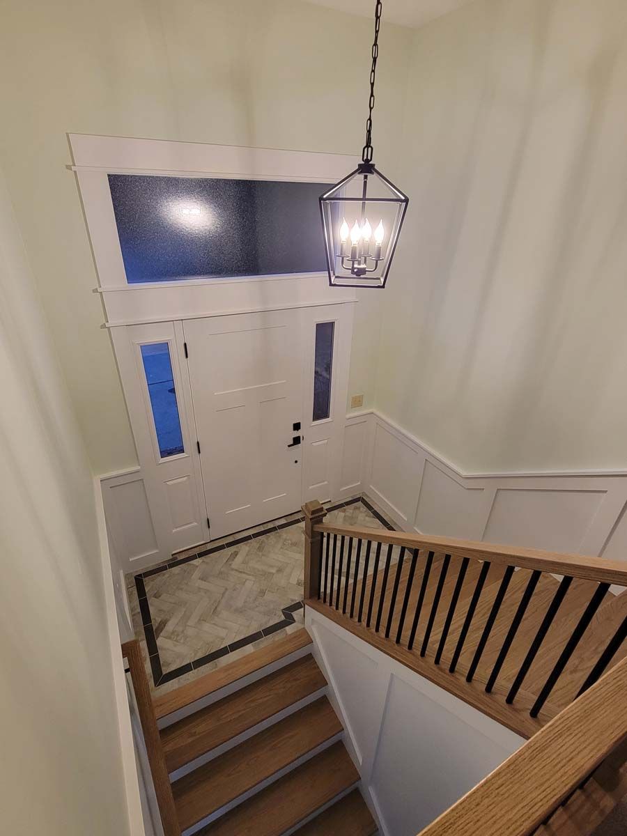 An aerial view of a staircase leading up to a door in a house.