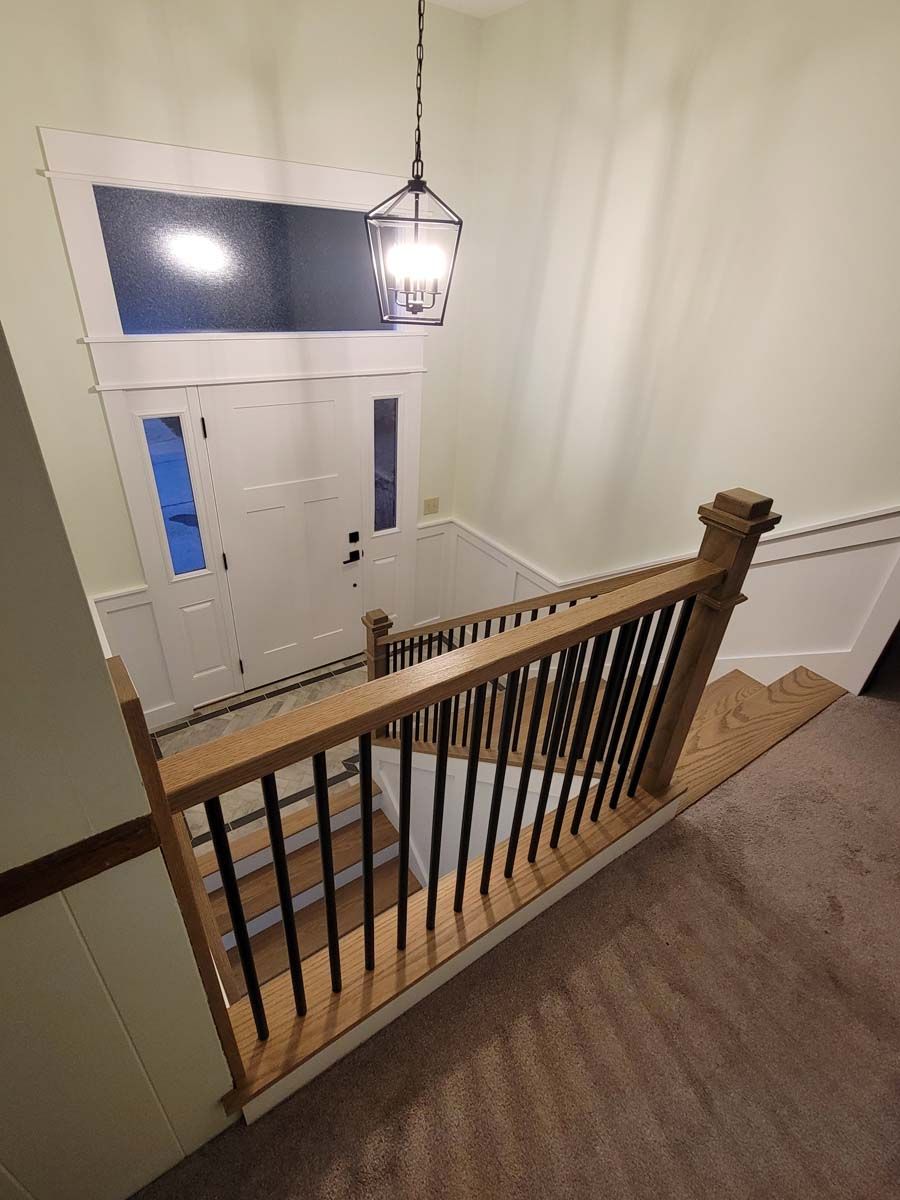 A view of a staircase from the second floor of a house.