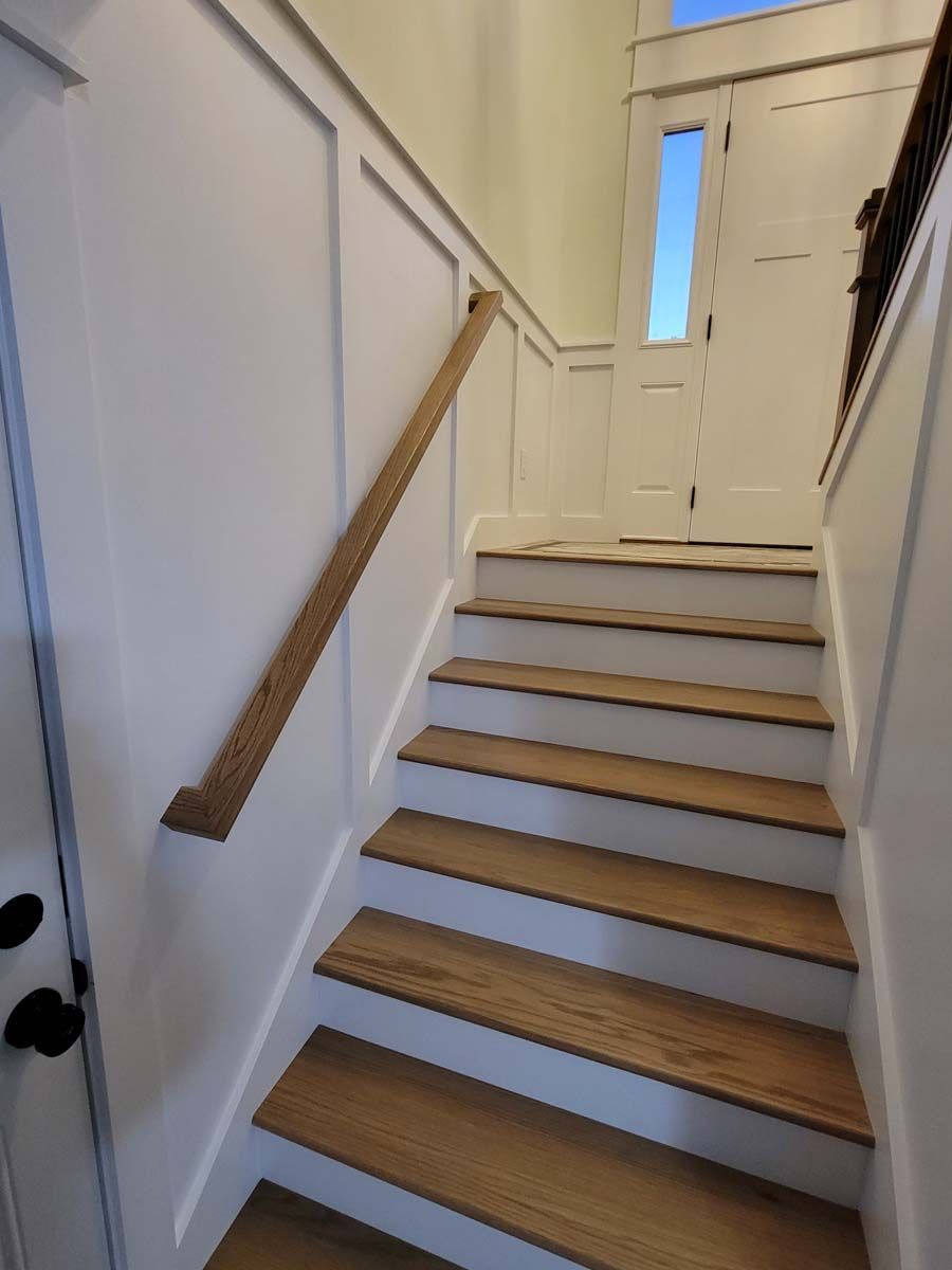 A set of wooden stairs leading up to a door