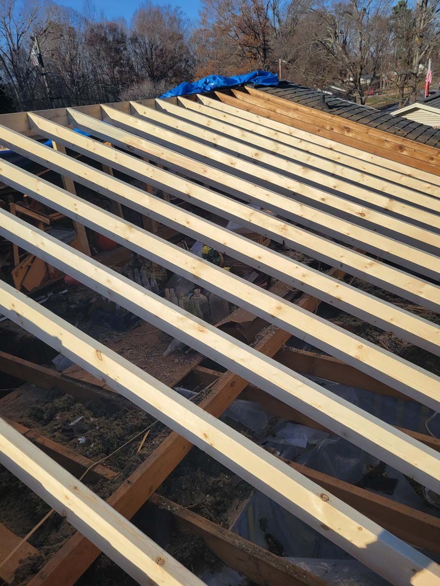 A roof is being built with wooden beams.
