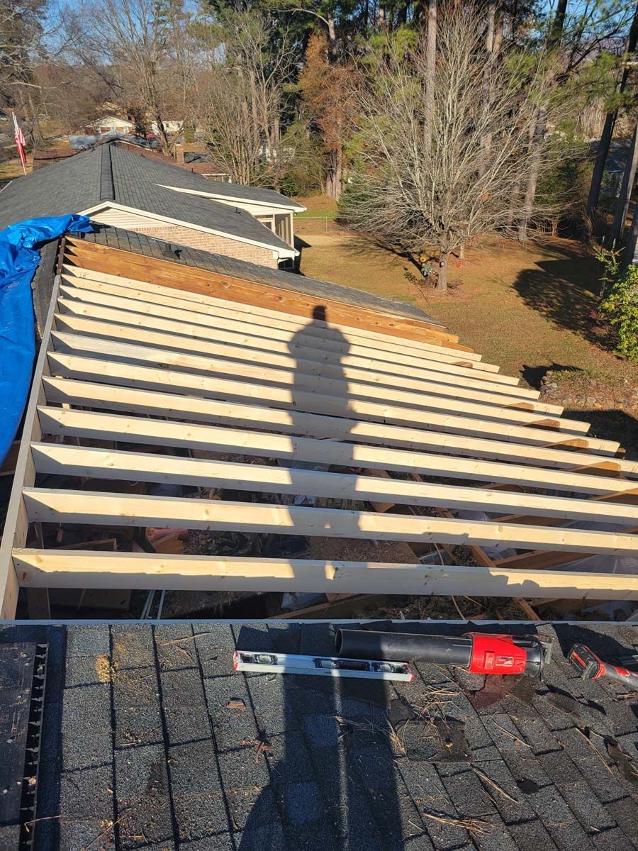 The roof of a house is being built with wooden beams.