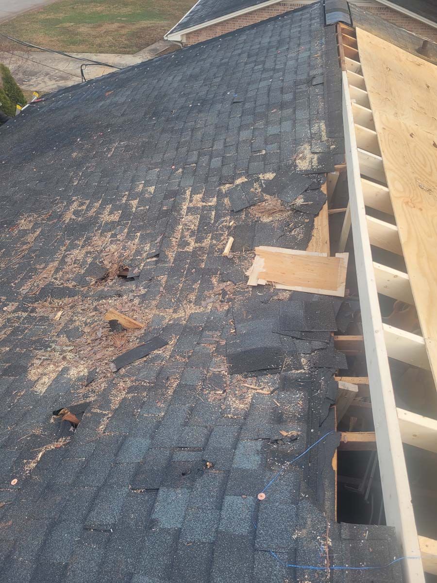 The roof of a house is being repaired and the shingles are missing.