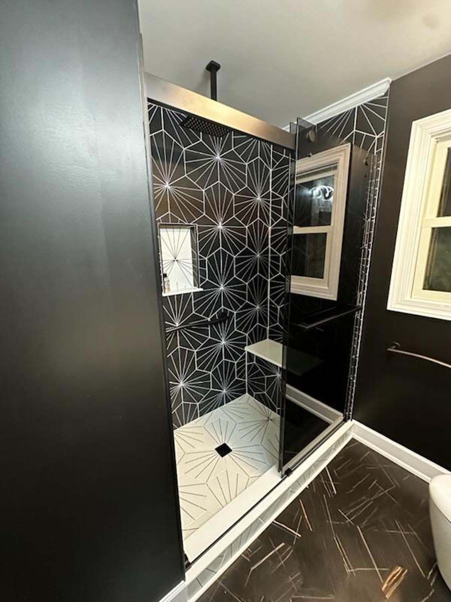 A bathroom with a walk in shower and a toilet.