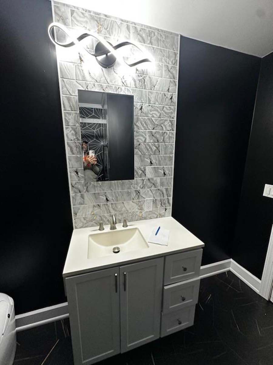 A bathroom with a sink , mirror and toilet.