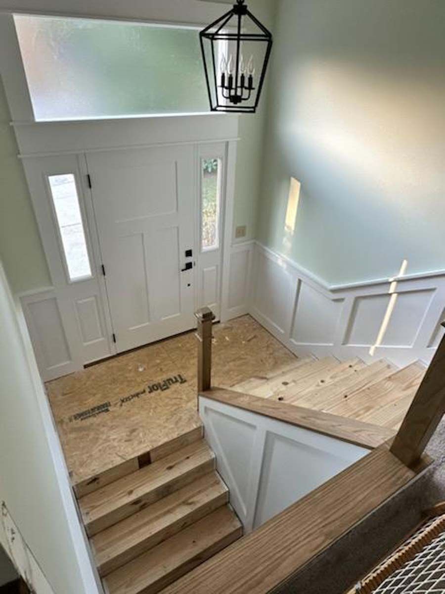 An aerial view of a staircase leading up to a door in a house.