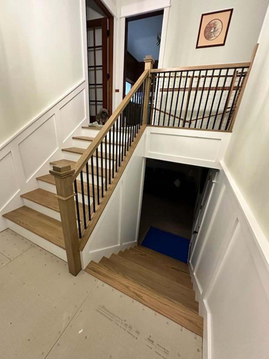 A wooden staircase leading up to the second floor of a house.