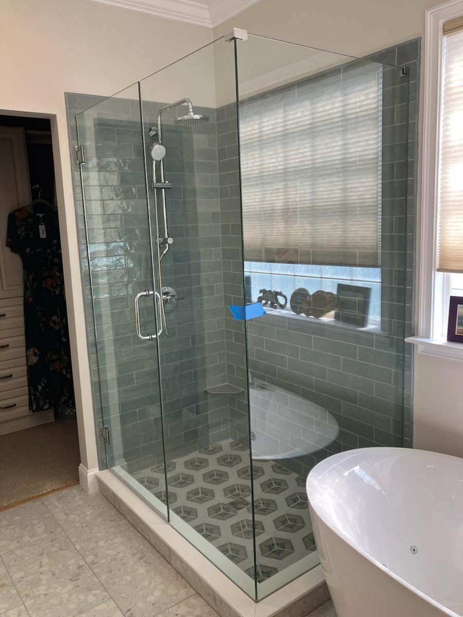 A bathroom with a walk in shower and a bathtub.