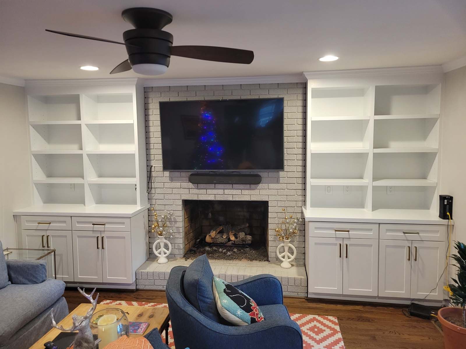 A living room with a fireplace and a flat screen tv.