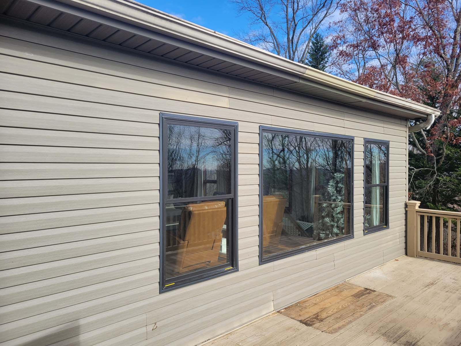 A house with a lot of windows and a deck.