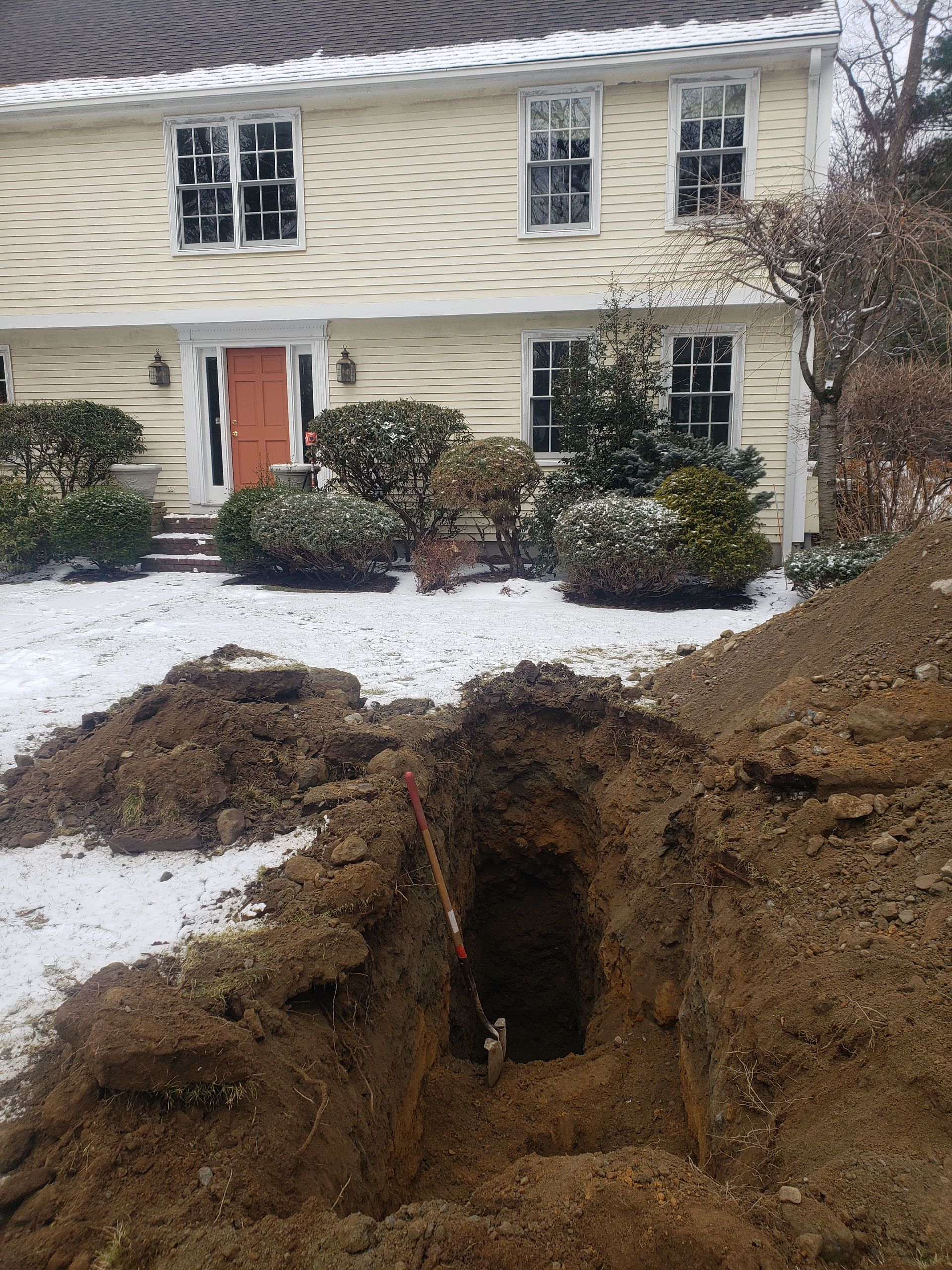 a large hole in the ground in front of a house