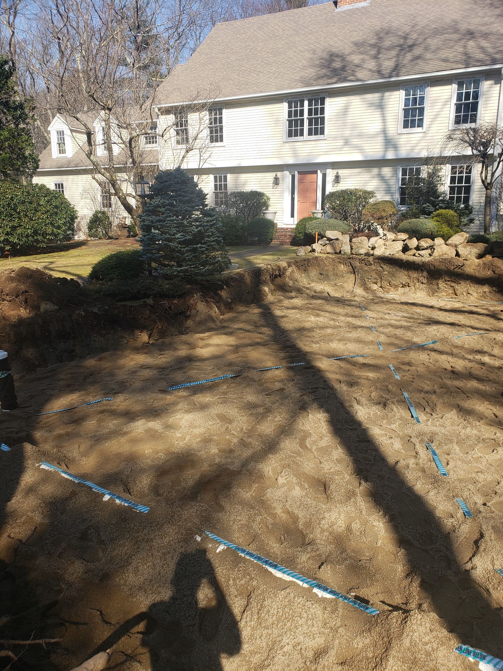 a large white house with a lot of dirt in front of it