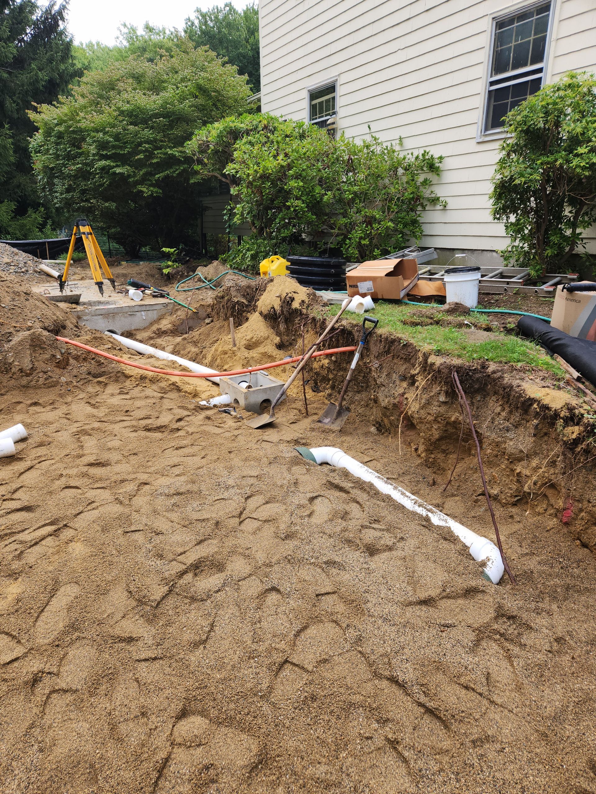 a large pile of dirt is sitting in front of a house