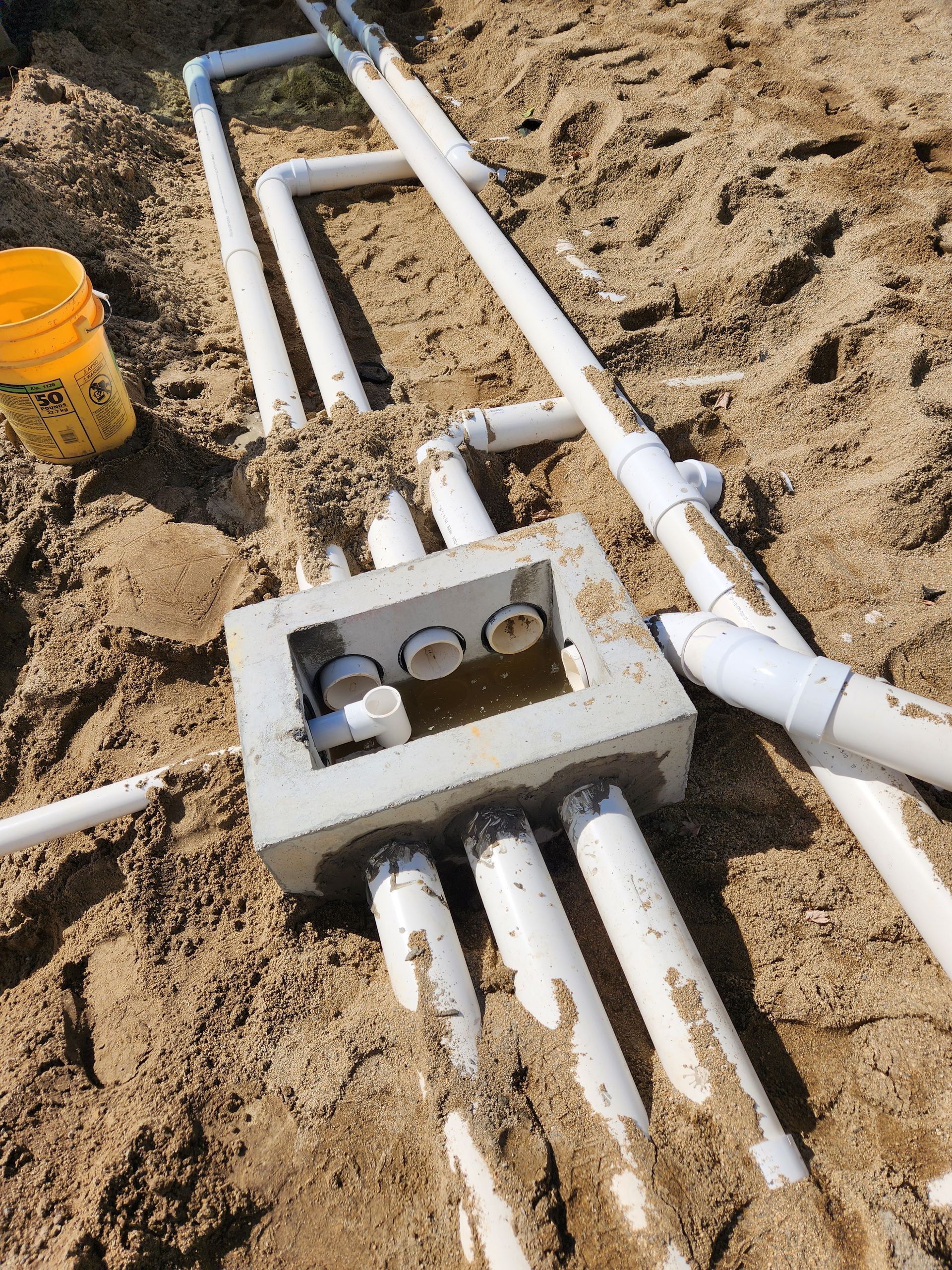 a bunch of white pipes are lying in the dirt