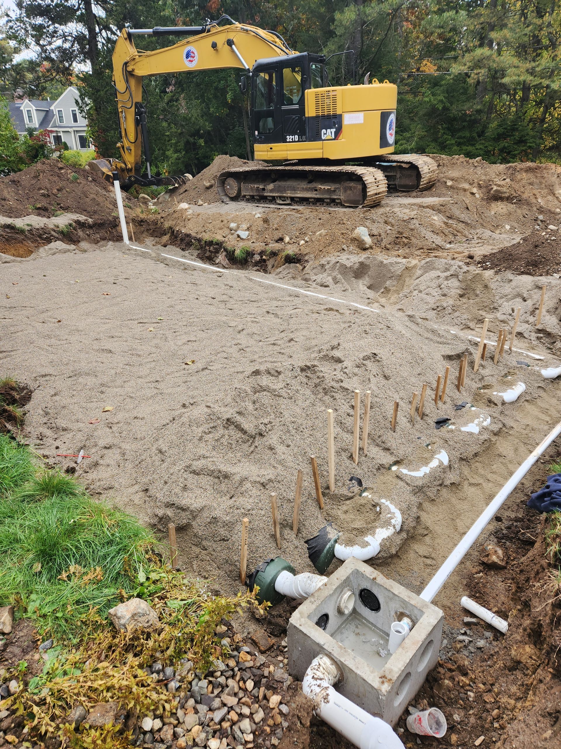 a yellow excavator is digging a hole in the dirt on a construction site