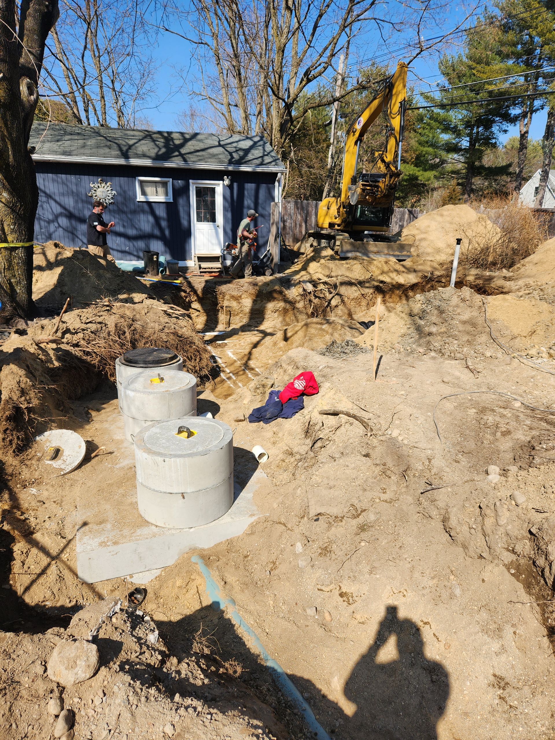 a septic tank is being installed in the dirt in front of a house