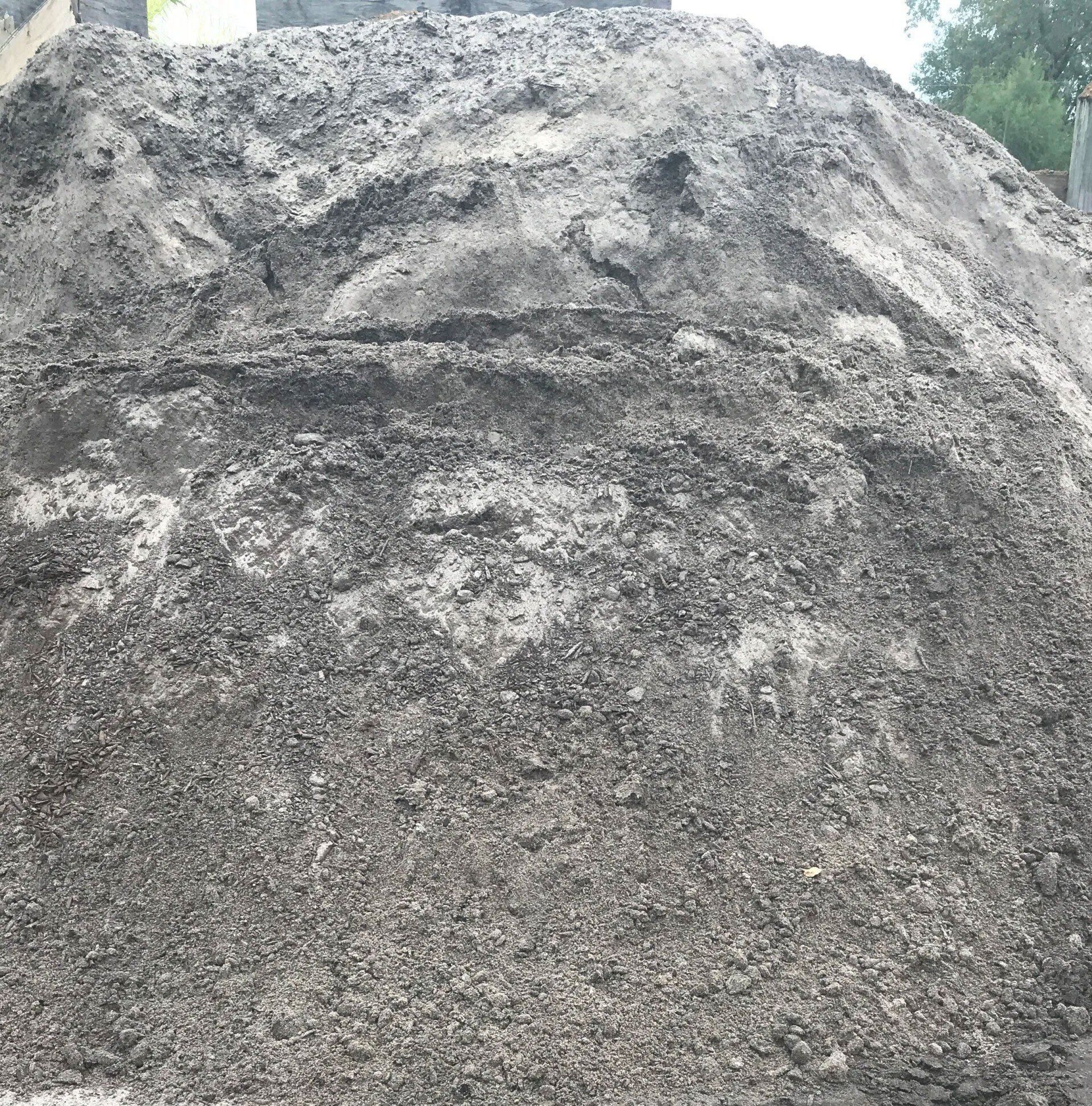 Close-up of a large gray gravel or stone pile outdoors under cloudy sky